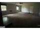 Large living room featuring neutral walls, carpet, fan and two windows at 2177 E Chester Cir, Conyers, GA 30013