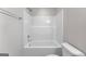Bathroom featuring a tiled tub with shower and white toilet, providing a clean and functional space at 527 Bohannon Rd # 12, Grantville, GA 30220