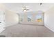 Large bedroom with three sunny windows, plush carpeting, and a ceiling fan for added comfort at 527 Bohannon Rd # 12, Grantville, GA 30220