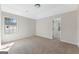 Carpeted primary bedroom bathed in natural light showing the neutral color scheme and open doorway to other rooms at 527 Bohannon Rd # 12, Grantville, GA 30220