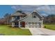 Beautiful two-story home with gray siding, stone accents, and a two-car garage at 527 Bohannon Rd # 12, Grantville, GA 30220