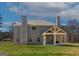 Back of home with covered patio with fireplace on a spacious lot with green grass and blue sky at 527 Bohannon Rd # 12, Grantville, GA 30220