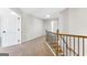 Upstairs hallway features a wooden staircase, leading to carpeted bedrooms and common areas at 527 Bohannon Rd # 12, Grantville, GA 30220