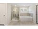 Bright bathroom featuring a shower, soaking tub, and dual windows for ample natural light at 515 Bohannon Rd # 13, Grantville, GA 30220