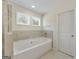 Bathroom featuring a bright soaking tub with natural light, shower and tiled floor at 515 Bohannon Rd # 13, Grantville, GA 30220