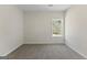 This bedroom has neutral walls and carpet with a window providing natural light at 515 Bohannon Rd # 13, Grantville, GA 30220
