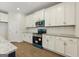 Kitchen with white cabinets, stainless steel microwave and oven, with granite counter tops and hardwood floors at 515 Bohannon Rd # 13, Grantville, GA 30220