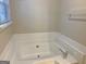 White bathtub with tile surround in bright bathroom at 2570 Picardy N Cir # B, Atlanta, GA 30349