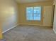 Spacious carpeted bedroom with large window and closet at 2570 Picardy N Cir # B, Atlanta, GA 30349