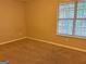 Carpeted bedroom with window and ample closet space at 2570 Picardy N Cir # B, Atlanta, GA 30349