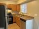 Kitchen with wood cabinets, stainless steel appliances, and tile floors at 2570 Picardy N Cir # B, Atlanta, GA 30349