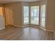 Bright living room featuring a bay window and laminate wood floors at 2570 Picardy N Cir # B, Atlanta, GA 30349