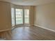 Living room with a bay window and laminate wood floors at 2570 Picardy N Cir # B, Atlanta, GA 30349