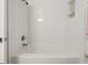 Clean white tiled bathtub and shower combo at 166 Chappell Nw Rd, Atlanta, GA 30314