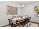 Elegant dining room with modern light fixture and seating for six at 166 Chappell Nw Rd, Atlanta, GA 30314