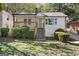 Charming white bungalow with a welcoming front porch and manicured landscaping at 166 Chappell Nw Rd, Atlanta, GA 30314