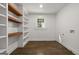 Laundry room with built-in shelves and hardwood floors at 166 Chappell Nw Rd, Atlanta, GA 30314