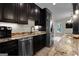 Basement kitchen with stainless steel appliances and granite countertops at 140 Haddock Pt, Brooks, GA 30205