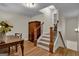 Basement staircase with wood railing and flooring, leading to additional living space at 140 Haddock Pt, Brooks, GA 30205