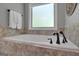 Relaxing bathroom with soaking tub and tile surround at 140 Haddock Pt, Brooks, GA 30205
