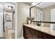 Elegant bathroom with granite countertops, dark wood cabinets and a large mirror at 140 Haddock Pt, Brooks, GA 30205