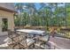 Large deck with a dining set overlooking the wooded backyard at 140 Haddock Pt, Brooks, GA 30205