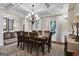 Bright dining room with hardwood floors, chandelier and seating for eight at 140 Haddock Pt, Brooks, GA 30205