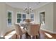 Bright dining room with large windows and a glass-top table at 140 Haddock Pt, Brooks, GA 30205