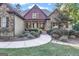 Front entrance with stonework, a covered porch, and landscaping at 140 Haddock Pt, Brooks, GA 30205