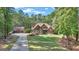 House exterior showcasing a stone and shingle two-story home with a three-car garage at 140 Haddock Pt, Brooks, GA 30205