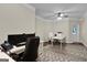 Bright home office with hardwood floors, ceiling fan, and ample workspace at 140 Haddock Pt, Brooks, GA 30205