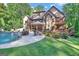 Beautiful home backing up to wooded area with a large pool and patio at 140 Haddock Pt, Brooks, GA 30205