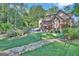 Beautiful home with spacious backyard, rock water feature, and lush landscaping at 140 Haddock Pt, Brooks, GA 30205