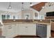 Kitchen island with granite countertop and stainless steel dishwasher at 140 Haddock Pt, Brooks, GA 30205