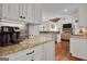 Kitchen features granite countertops, white cabinets and coffee bar at 140 Haddock Pt, Brooks, GA 30205