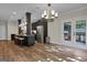 Open floor plan boasts a kitchen island, stainless steel appliances, and French doors to patio at 140 Haddock Pt, Brooks, GA 30205