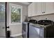 Laundry room with washer, dryer, cabinets, and countertop space at 140 Haddock Pt, Brooks, GA 30205