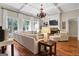 Open living room with hardwood floors, sectional sofa and fireplace at 140 Haddock Pt, Brooks, GA 30205