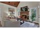 Cozy living room boasts a stone fireplace and large windows at 140 Haddock Pt, Brooks, GA 30205