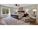 Main bedroom with large bed, sitting area, and plenty of natural light at 140 Haddock Pt, Brooks, GA 30205