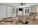 Spacious main bedroom with large bed, en-suite bathroom and hardwood floors at 140 Haddock Pt, Brooks, GA 30205