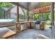 Outdoor kitchen with pergola, grill, and stone counters under covered patio at 140 Haddock Pt, Brooks, GA 30205