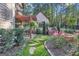 Charming patio with pergola, lush landscaping, and stone pathway at 140 Haddock Pt, Brooks, GA 30205