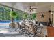 Covered patio with seating area and ceiling fan overlooks the pool at 140 Haddock Pt, Brooks, GA 30205