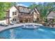 Luxury home with inviting pool, expansive patio, and lush landscaping at 140 Haddock Pt, Brooks, GA 30205