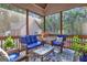 Relaxing screened porch with wicker furniture and wooded views at 140 Haddock Pt, Brooks, GA 30205