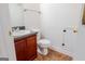 Cozy bathroom featuring a single sink vanity, toilet, and tile flooring at 516 Jaclyn Cir, Mcdonough, GA 30253