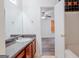 Bathroom with sink vanity and an open doorway to a bedroom with hardwood flooring at 516 Jaclyn Cir, Mcdonough, GA 30253