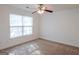 The bedroom has neutral carpet, a ceiling fan, and natural light from the window at 516 Jaclyn Cir, Mcdonough, GA 30253