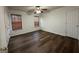 A spacious bedroom features wood flooring, a ceiling fan, and natural light from two windows at 516 Jaclyn Cir, Mcdonough, GA 30253